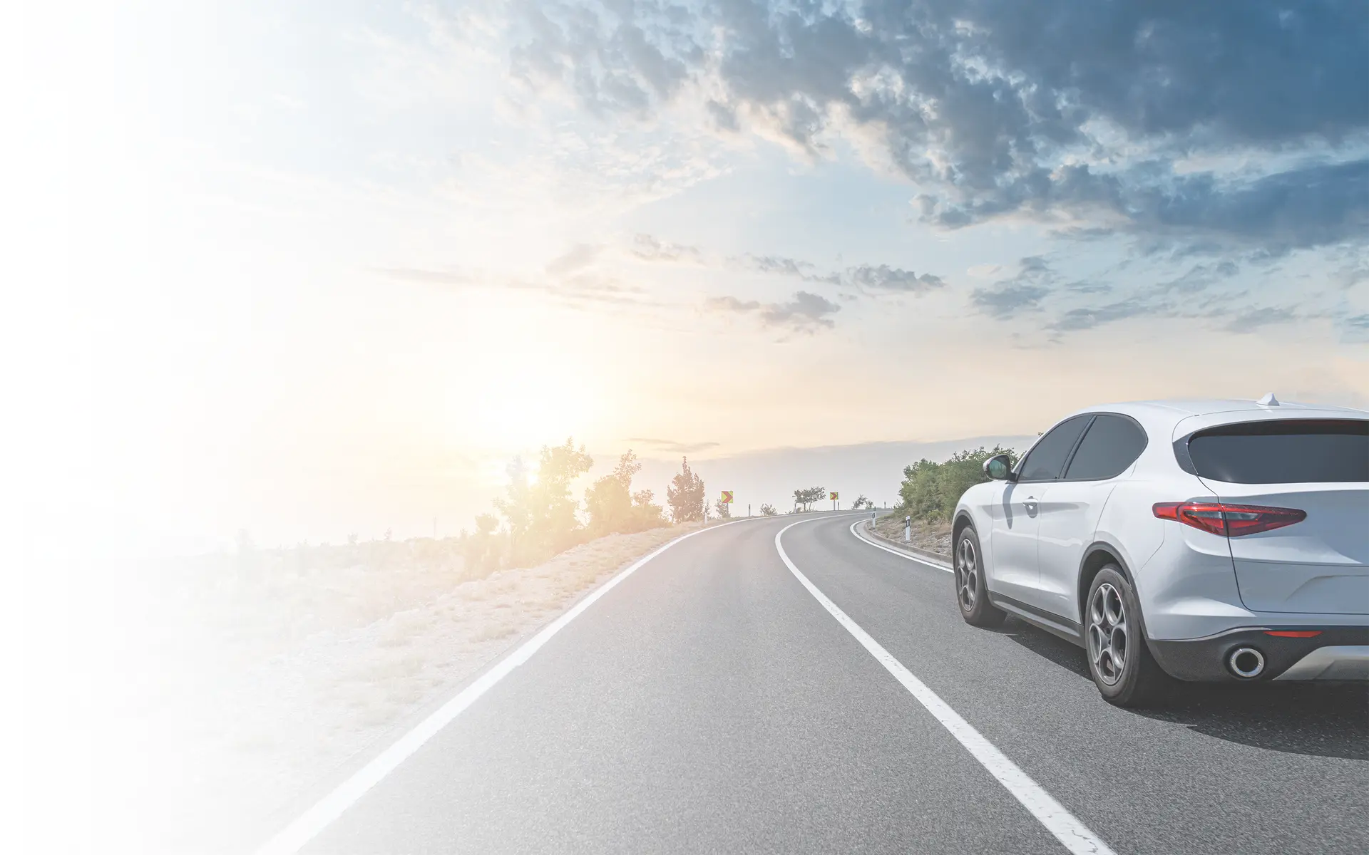 Car on the road surrounded by a magnificent natural landscape.