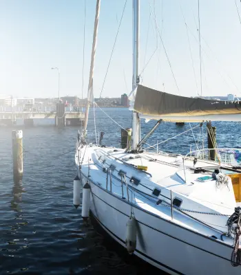 A sailboat in a harbor.